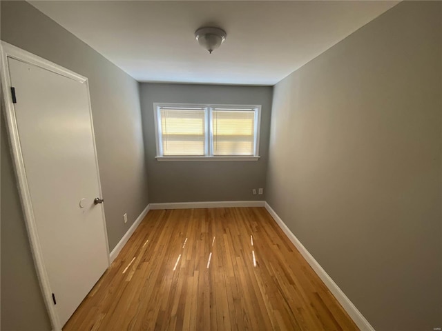 empty room with light hardwood / wood-style flooring