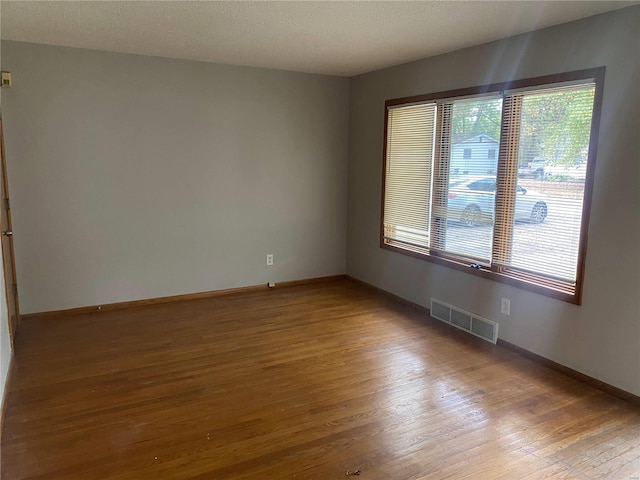 spare room featuring hardwood / wood-style floors