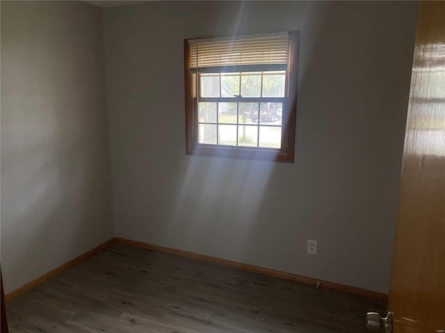 spare room with dark hardwood / wood-style floors