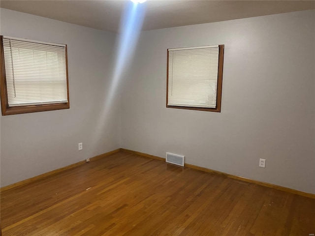 unfurnished room featuring hardwood / wood-style flooring