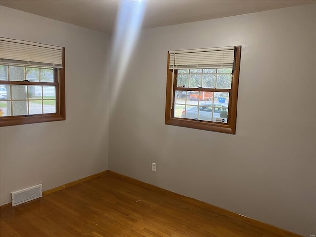 unfurnished room with hardwood / wood-style floors