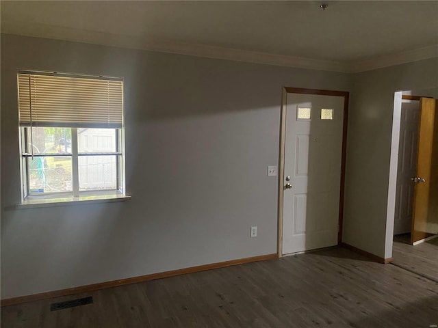 unfurnished room with wood-type flooring and ornamental molding