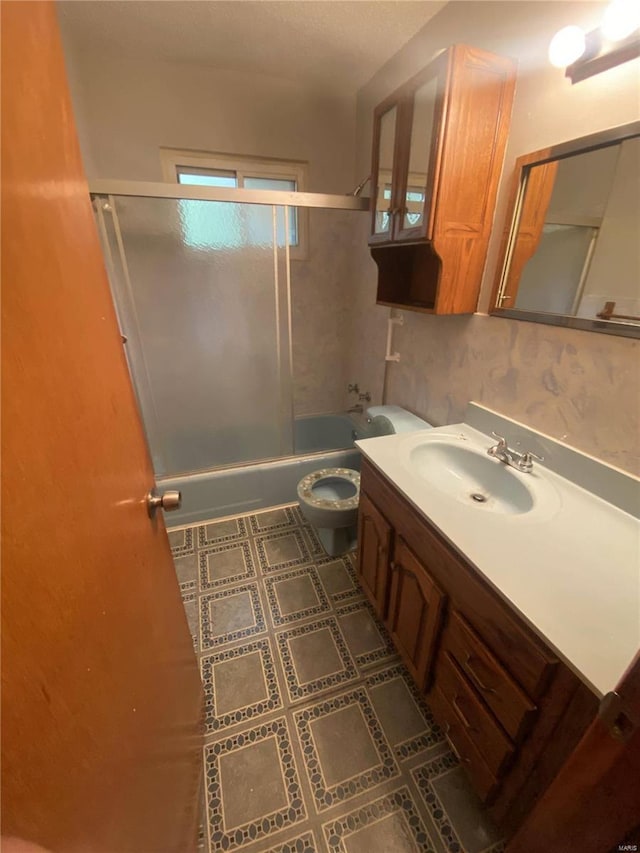 full bathroom featuring toilet, vanity, and bathing tub / shower combination