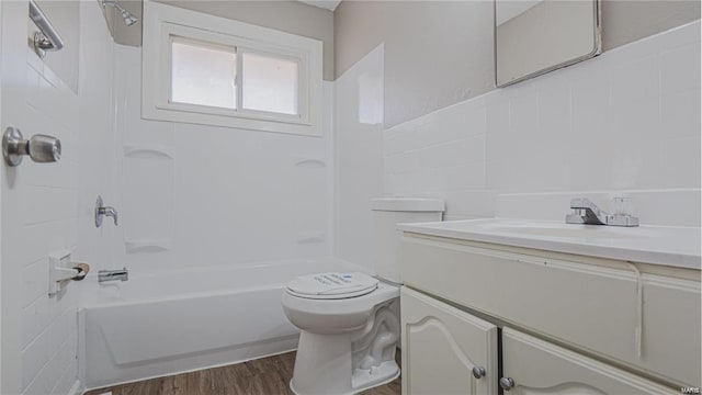 full bathroom featuring toilet, vanity, washtub / shower combination, and hardwood / wood-style flooring