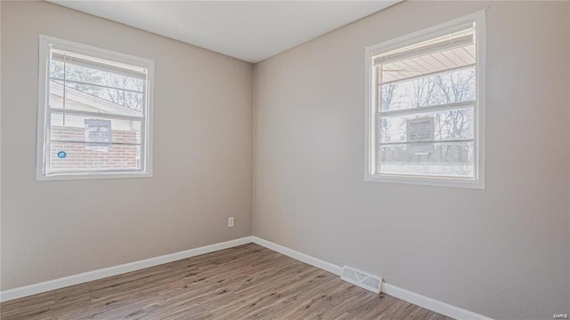 unfurnished room with light hardwood / wood-style flooring