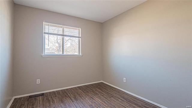 spare room with dark wood-type flooring