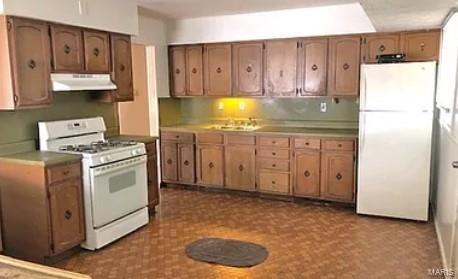 kitchen with white appliances and sink