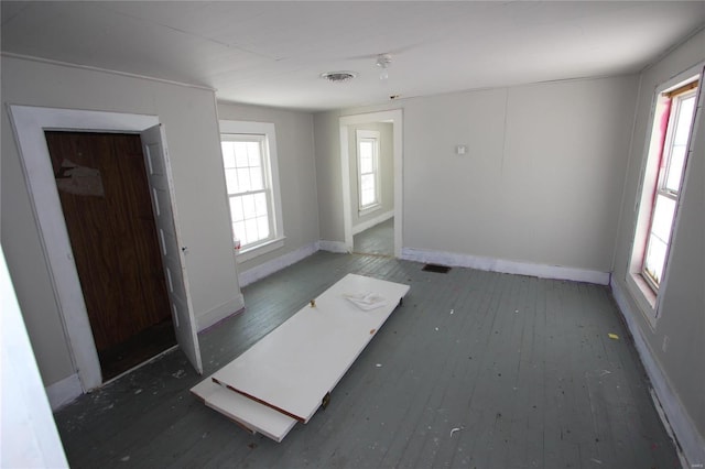 unfurnished room with dark wood-type flooring