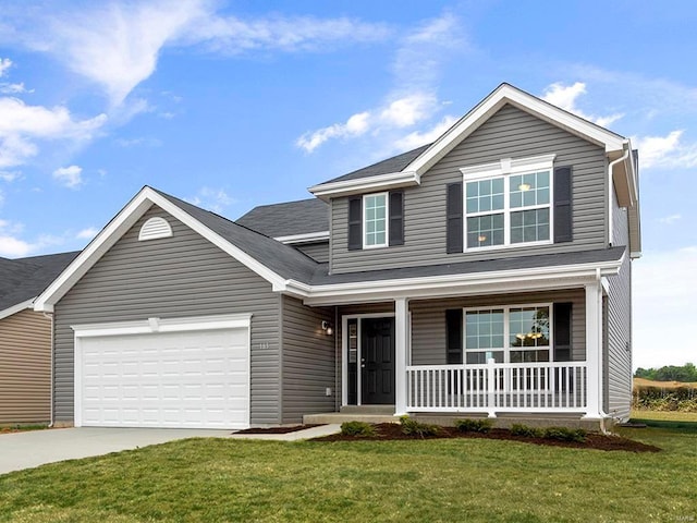 view of property featuring a porch, a garage, and a front lawn