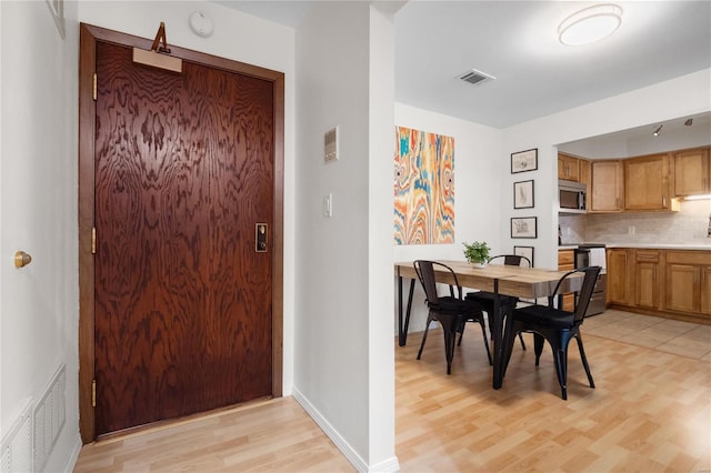 dining area featuring sink and light hardwood / wood-style flooring