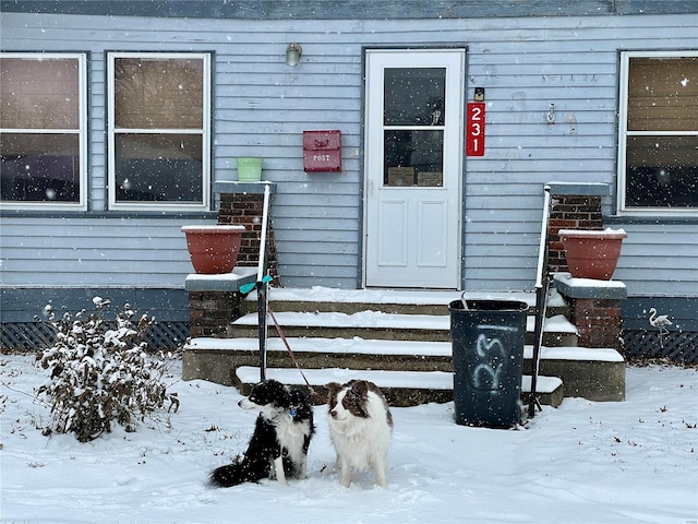 view of snow covered property entrance