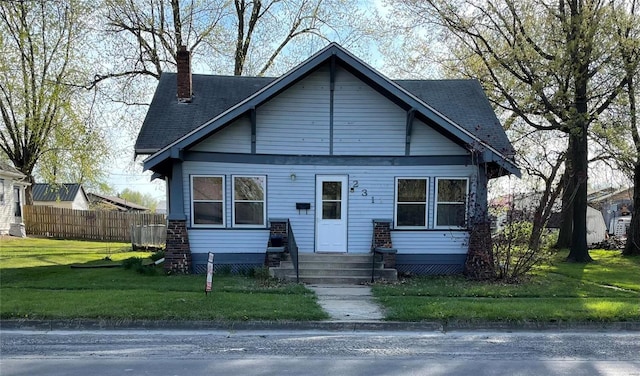 bungalow-style home with a front yard