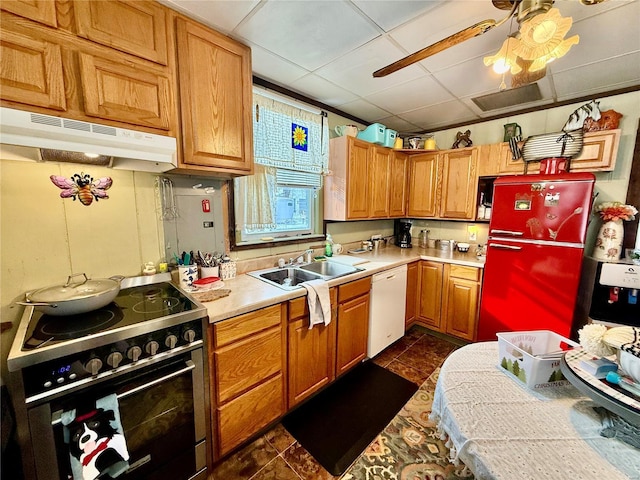 kitchen with a paneled ceiling, stainless steel range, white dishwasher, sink, and fridge