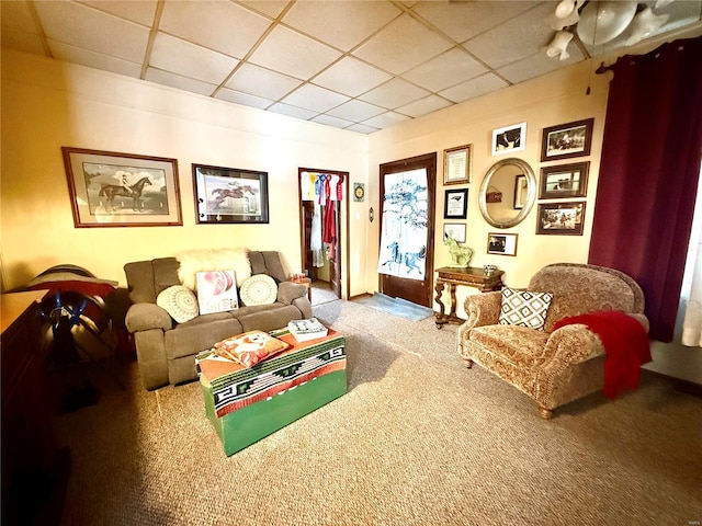 carpeted living room with a paneled ceiling