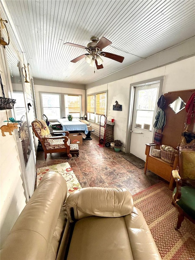 sunroom with ceiling fan and wooden ceiling