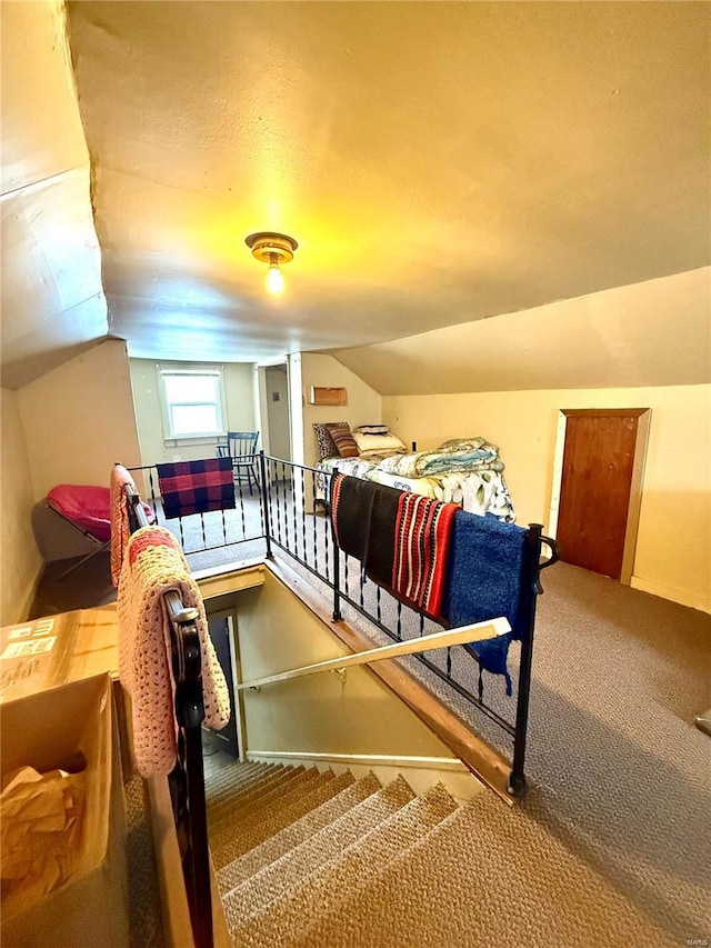 carpeted bedroom featuring lofted ceiling