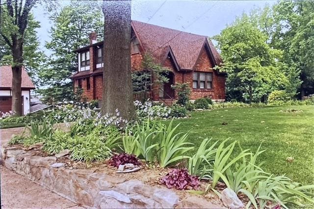 view of home's exterior featuring a chimney and a yard