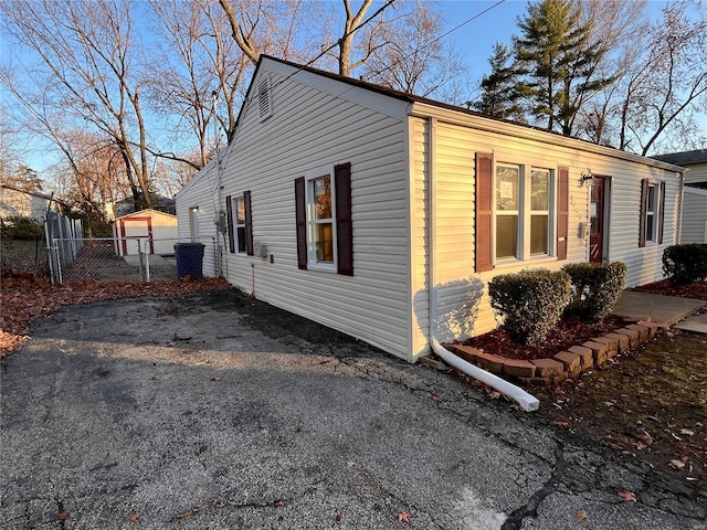 view of side of home with a garage and an outdoor structure