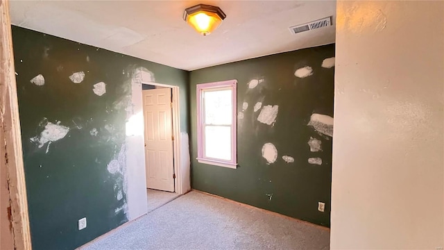 unfurnished room featuring light colored carpet