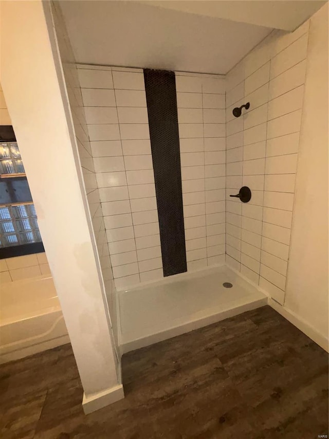 bathroom featuring tiled shower and hardwood / wood-style floors