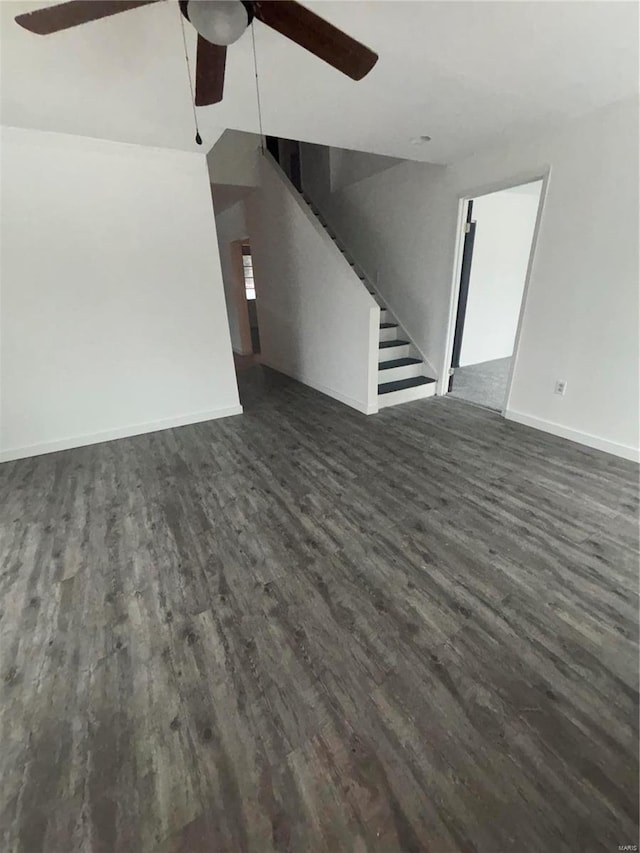 unfurnished living room featuring dark hardwood / wood-style floors and ceiling fan