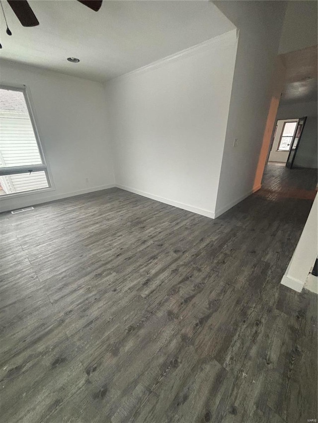 empty room with dark hardwood / wood-style floors and ceiling fan