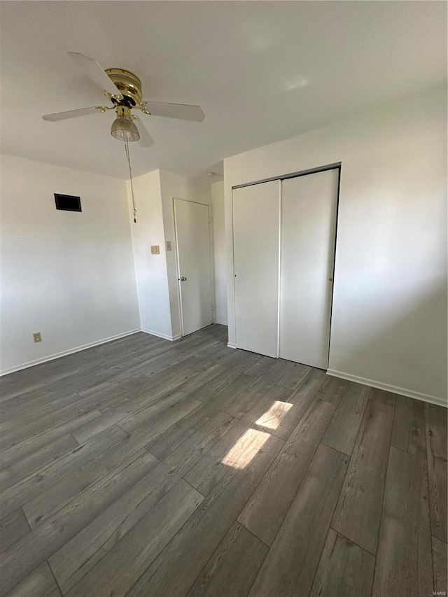 unfurnished bedroom featuring dark hardwood / wood-style flooring and ceiling fan