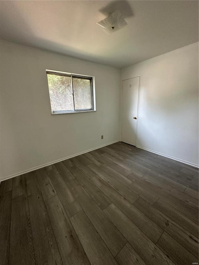 unfurnished room featuring dark hardwood / wood-style flooring