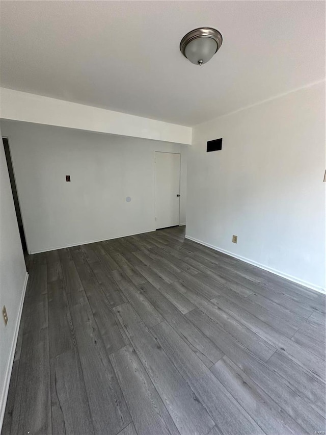 spare room featuring dark hardwood / wood-style flooring