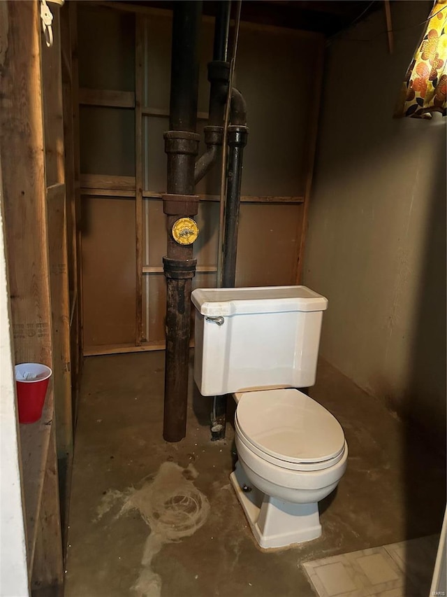 bathroom with concrete floors and toilet