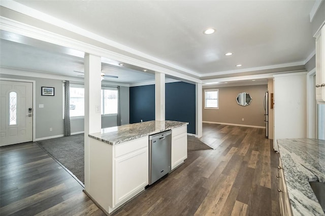 kitchen featuring light stone counters, ceiling fan, dishwasher, white cabinets, and plenty of natural light