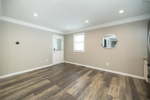 spare room featuring dark hardwood / wood-style floors and ornamental molding