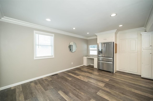 kitchen featuring white cabinets, dark hardwood / wood-style floors, stainless steel fridge, and ornamental molding