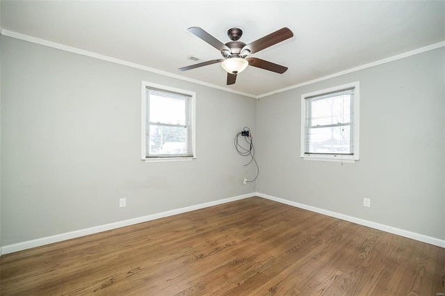 empty room featuring hardwood / wood-style flooring, ceiling fan, and ornamental molding