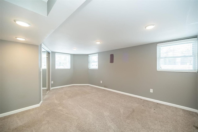 basement featuring light carpet