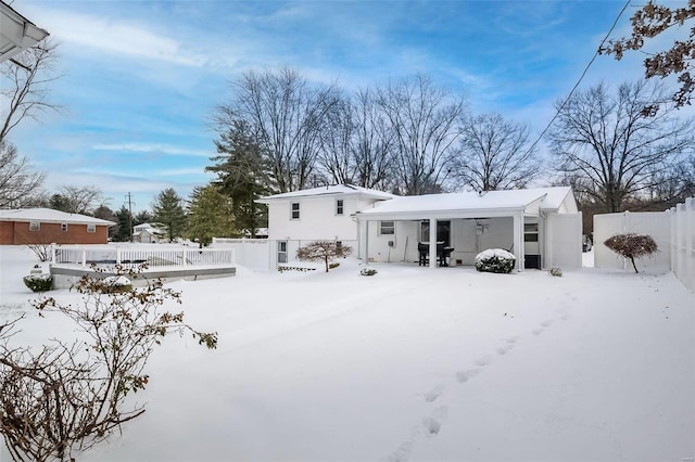 view of snow covered rear of property