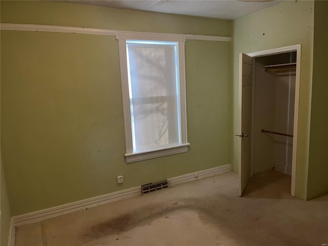 unfurnished bedroom featuring a closet, visible vents, and baseboards