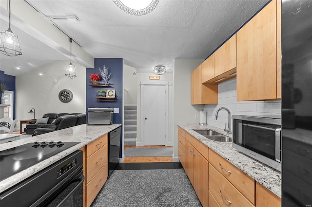 kitchen featuring oven, decorative backsplash, a sink, a textured ceiling, and stainless steel microwave