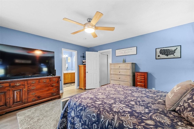 bedroom featuring ensuite bath, ceiling fan, and wood finished floors