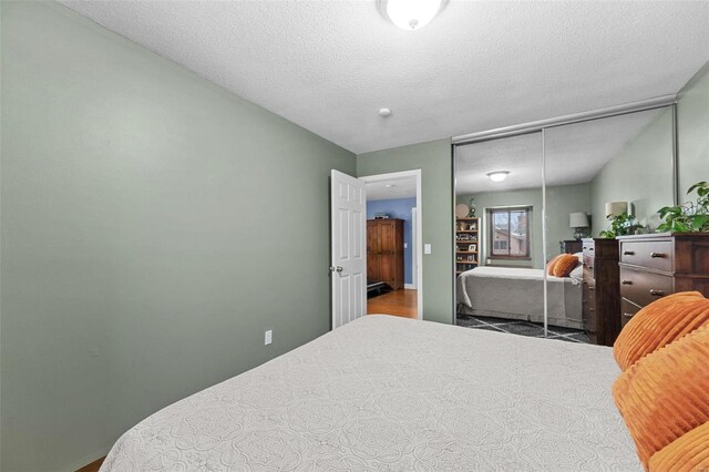 bedroom with a closet and a textured ceiling