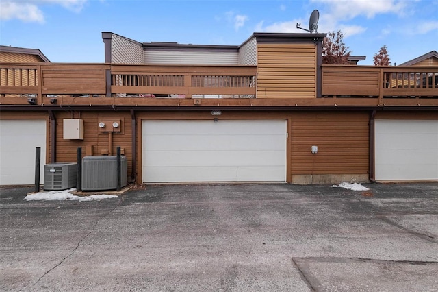 exterior space with cooling unit and aphalt driveway