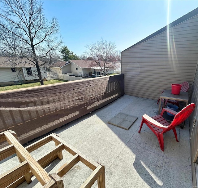 view of patio with a balcony and a residential view