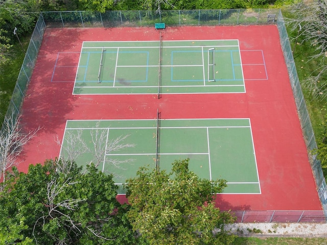 view of tennis court featuring fence