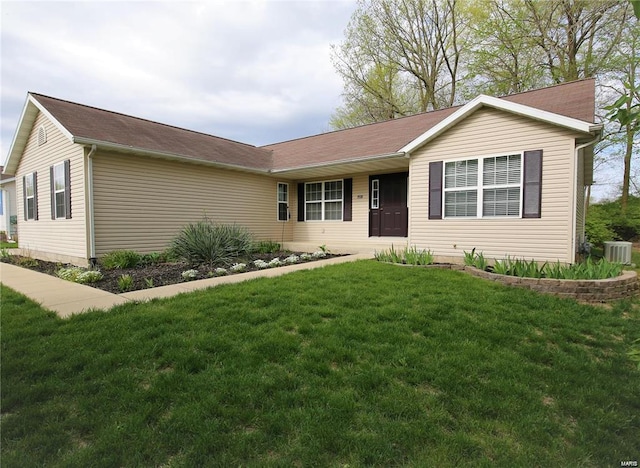 ranch-style house with central AC and a front lawn