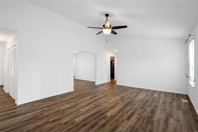 unfurnished room with ceiling fan, high vaulted ceiling, and dark wood-type flooring