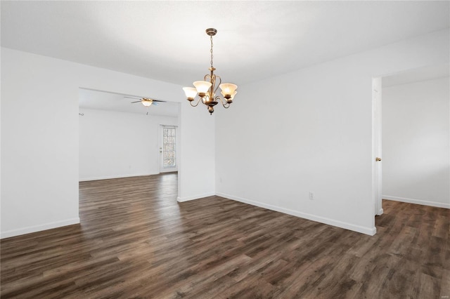 unfurnished room featuring ceiling fan with notable chandelier and dark wood-type flooring