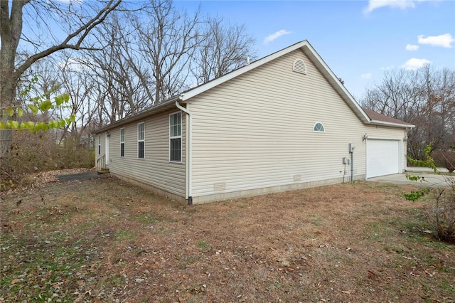 view of side of home featuring a garage