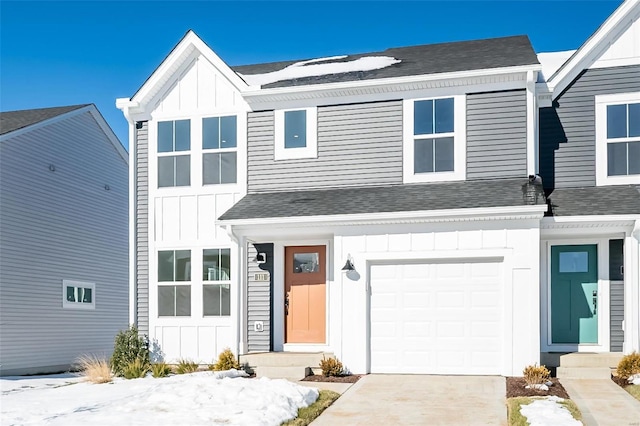 view of front of home with a garage, roof with shingles, and board and batten siding