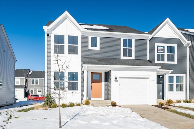 multi unit property with roof with shingles, solar panels, an attached garage, board and batten siding, and driveway