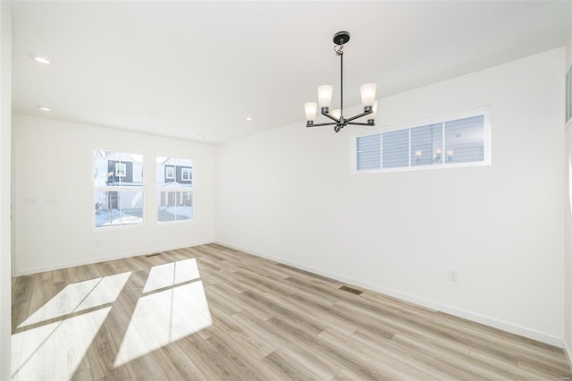 unfurnished room featuring recessed lighting, visible vents, a chandelier, light wood-type flooring, and baseboards